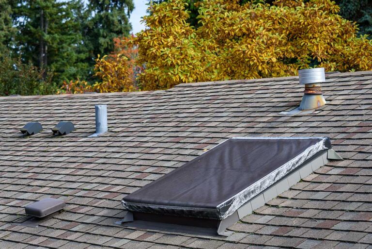 Homeowner viewing roof shingles and gutters from the ground before a severe storm.